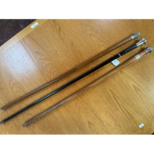 365 - Three vintage silver mounted walking canes