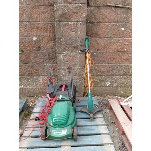 31 - A Qualcast electric lawn mower together with a Draper electric strimmer