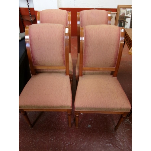 217 - A set of four scroll back bedroom chairs upholstered in silk