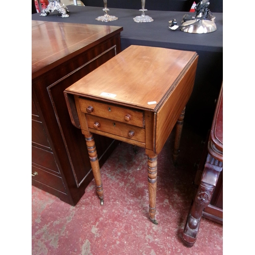 283 - A Georgian mahogany drop leaf work table fitted two short drawers