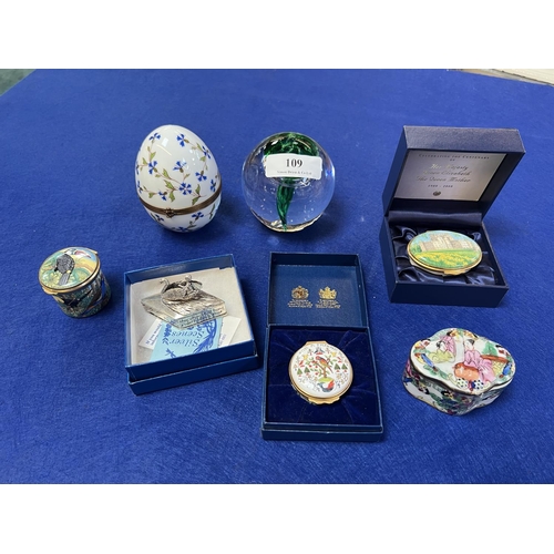 109 - A collection of enamel trinket boxes, a paper weight, a Limoges egg etc.