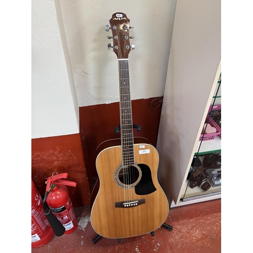 133 - An Aria acoustic guitar complete with stand