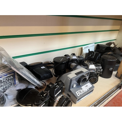 140 - A collection of cameras and associated photographic equipment