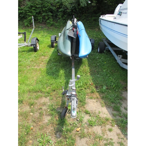 28 - Two ocean kayaks, paddles and accessories mounted upon a bespoke trailer