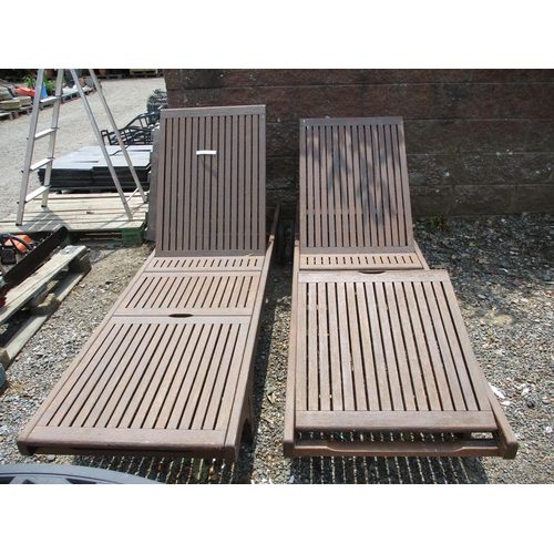 36 - A pair of teak adjustable sun loungers