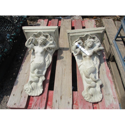 47 - A pair of reconstituted stone figural wall sconces modelled in the form of mermaids and clam shells