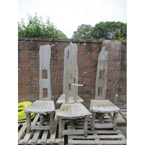 52 - A set of four reclaimed timber garden chairs of primitive form