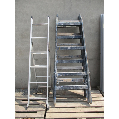 73 - A pair of wooden folding decorating trestles together with an aluminium combination ladder