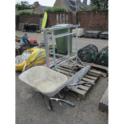 86 - Three galvanised building trestles, a wheel barrow, a shovel and a roll of plastic sheeting