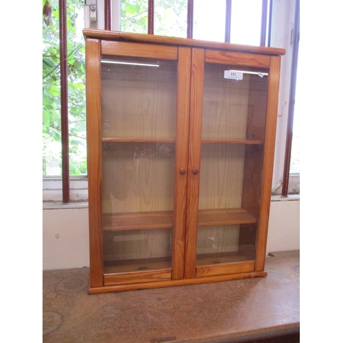 152 - A glazed pine display cabinet of diminutive form