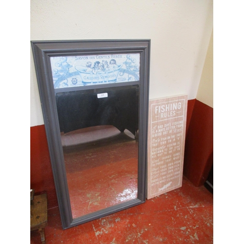 225 - A bevelled wall mirror together with a wooden sign pertaining to fishing