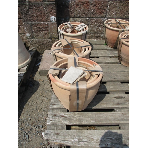 107 - Three sets of three terracotta graduated planters