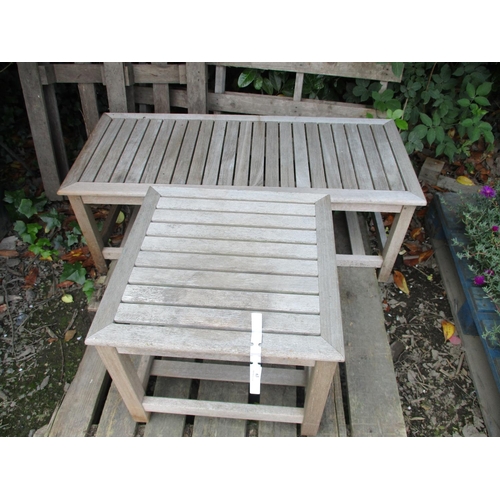 63 - A rectangular teak patio table together with a similar square table