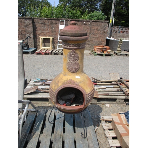 79 - A large terracotta chiminera on wrought metal stand