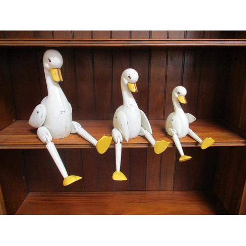 279 - A set of three graduated naïve wooden and articulated ducks