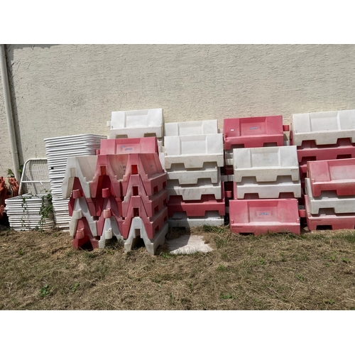 11 - A quantity of red and white road barriers complete with upper metallic barrier extensions