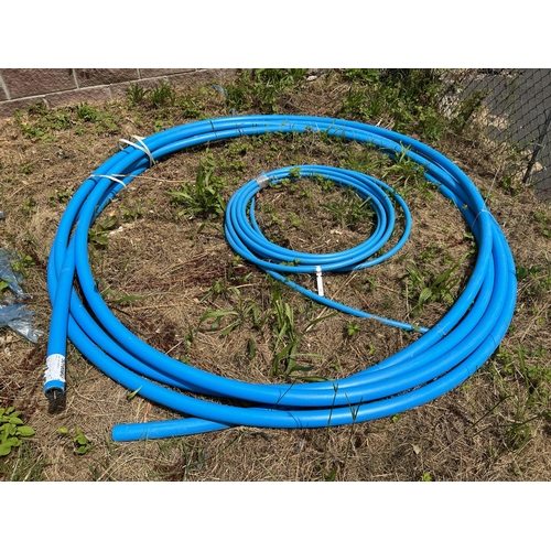 24 - Two coils of blue PVC water pipe (50mm and 25mm)