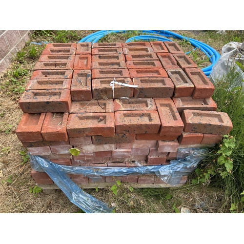 25 - A pallet of red bricks