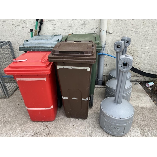 72 - Two green PVC wheelie bins together with a brown PVC wheelie, a red wheelie PVC bin, three cigarette... 