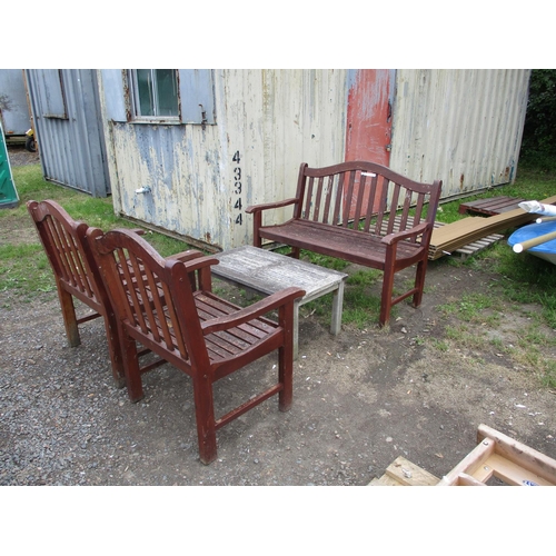 27 - A teak garden bench together with two matching armchairs and a teak occasional table