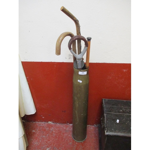 395 - A large brass ammunition shell case dated 1942 now utilised as an umbrella and stick stand and conta... 