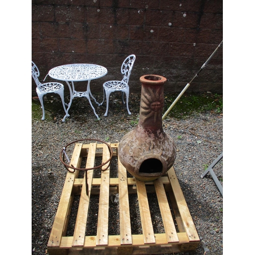 37 - A terracotta chiminera complete with wrought metal stand