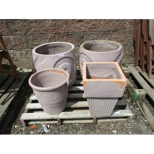 46 - A pair of large reconstituted stone circular planters with swirled designs together with two others