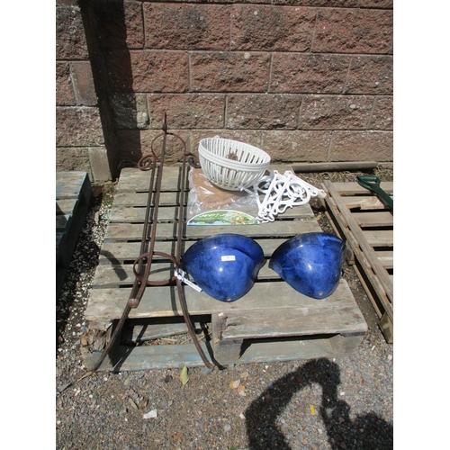 53 - A wrought metal plant stand, salt glazed wall sconces, hanging baskets complete with brackets etc.