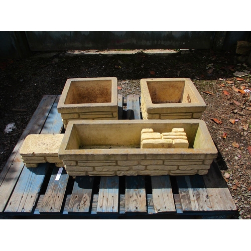 57 - A pair of Sandford stone planters and stands together with a matching trough