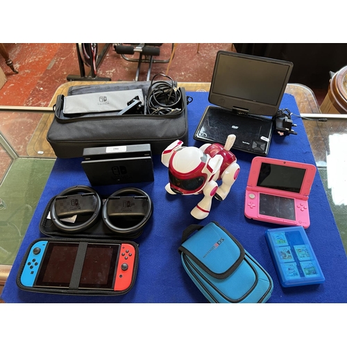 286 - A Nintendo Switch, a Nintendo 3 DS XL together with various games and accessories and a Technika por... 