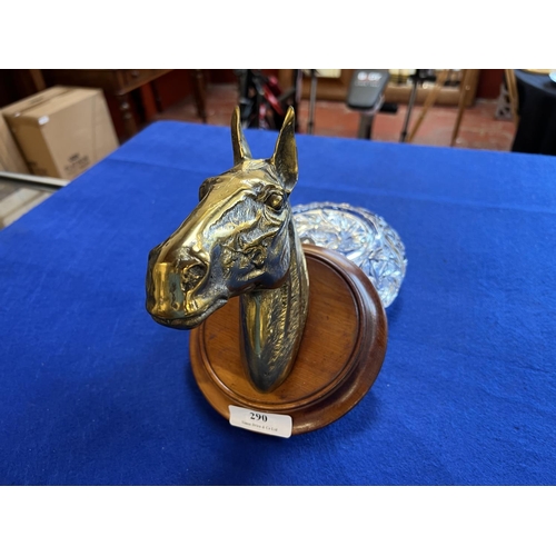 290 - A brass model of a horse's head mounted upon mahogany