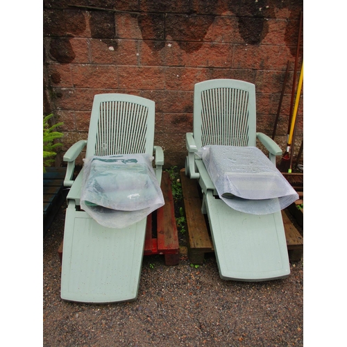 50 - A pair of green PVC wheeled sun loungers complete with cushions