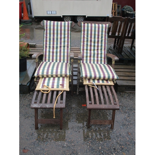 90 - A pair of teak steamer chairs complete with cushions