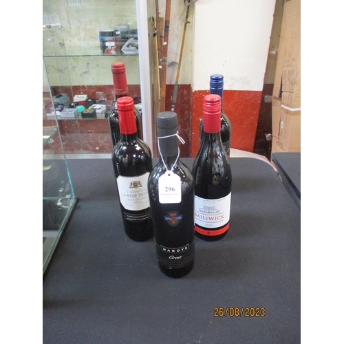 296 - Five bottles of assorted red wines