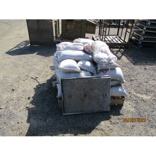 24 - A quantity of sand bags together with a galvanised man hole and cover