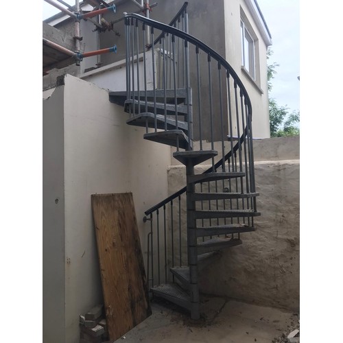 56 - A galvanised thirteen tread spiral staircase complete with hand rail and balustrades (2.8m high)