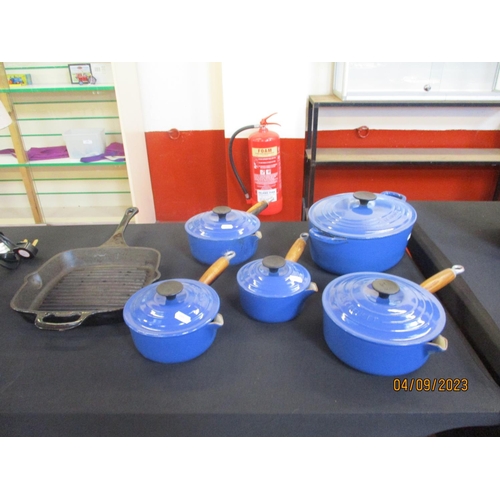 175 - A graduated set of four Le Creuset lidded saucepans together with a matching oval lidded casserole d... 