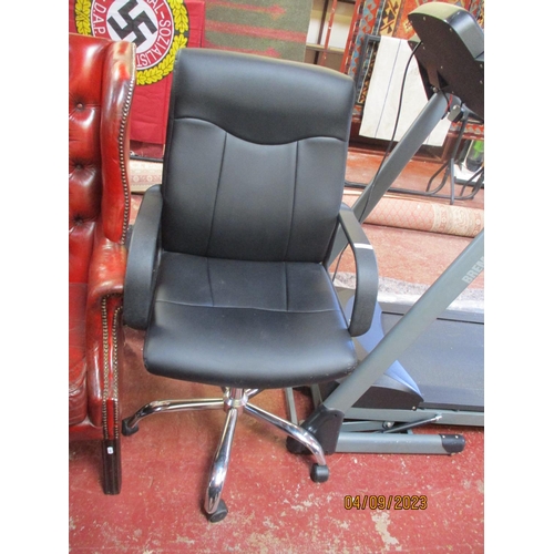 189 - A revolving director's chair upholstered in black faux leather