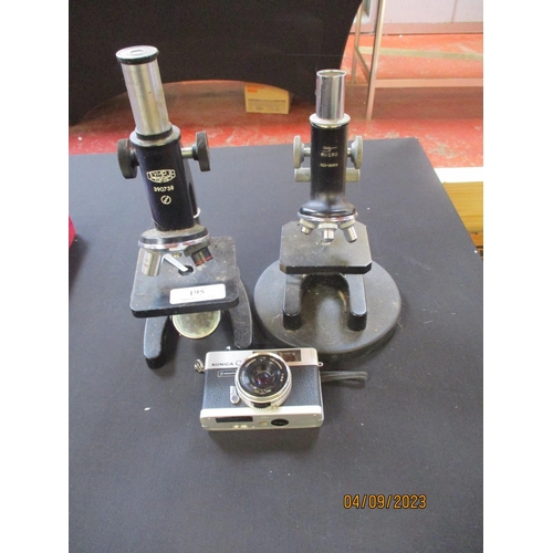 195 - Two mid-century laboratory microscopes together with a Konica C35 camera