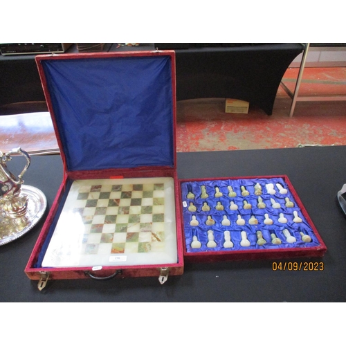 196 - A boxed onyx chess set comprising of chess pieces and board