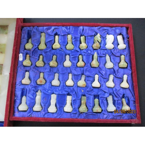 196 - A boxed onyx chess set comprising of chess pieces and board