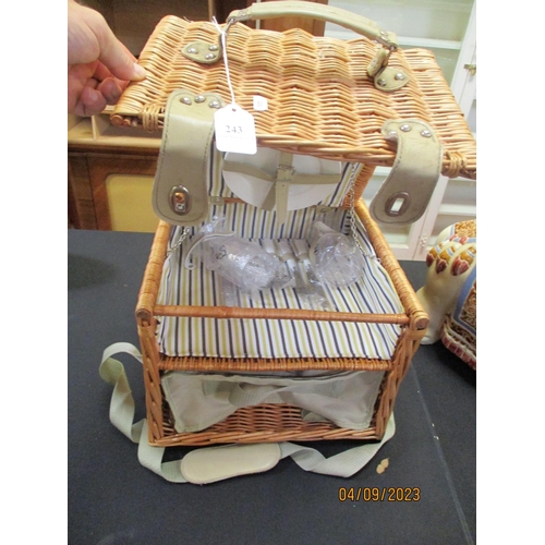 243 - A wicker picnic hamper containing a two place picnic setting