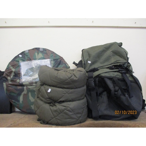 388 - A quick pitch compact camouflage tent, a sleeping bag and a back pack