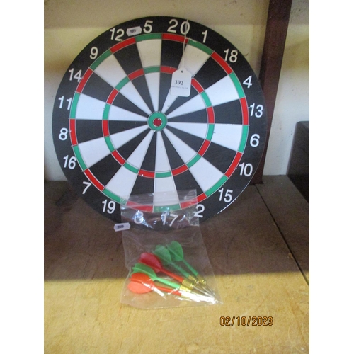 392 - A dart board and darts