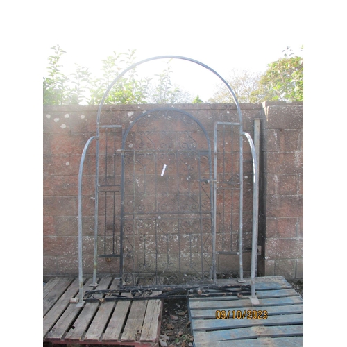 51 - A wrought metal arched garden gate complete with frame and surround