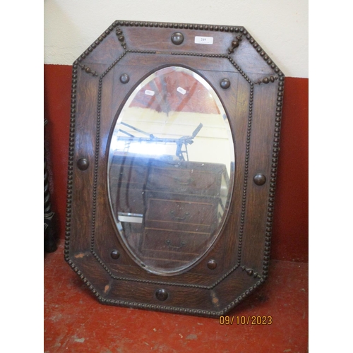 249 - An Edwardian oak oval bevelled framed wall mirror