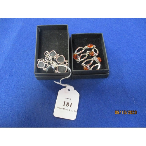 181 - Two silver bracelets, one set with amber the other onyx