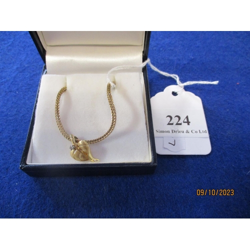 224 - A diamond pendant modelled in the form of a leaf suspended from a chain