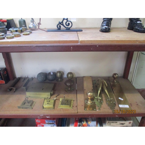 134 - A collection of brass door furniture etc.