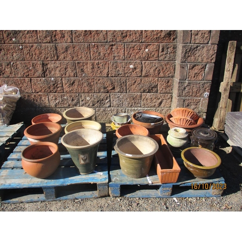 39 - Assorted terracotta and salt glazed stone ware planters, an enamel cauldron etc.